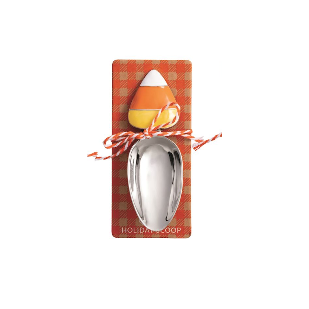 Spoon with candy corn design on a plaid card, on a white background