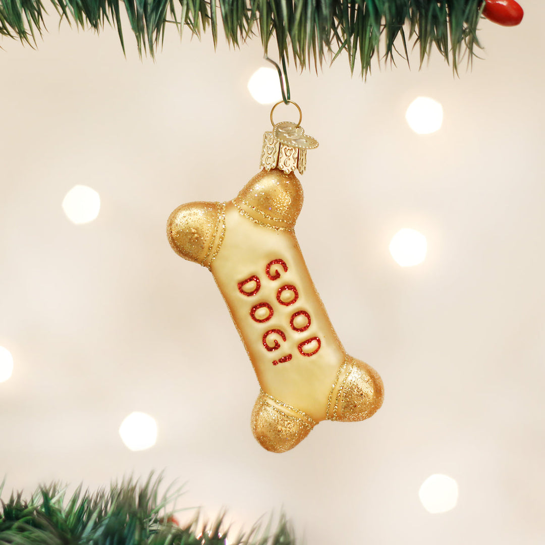 Decorative bone-shaped ornament with 'GOOD DOG' on a Christmas tree.
