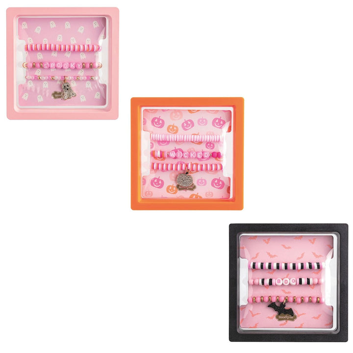 Three Halloween-themed bracelet sets displayed in packaging with a variety of colors and designs, including spider and pumpkin charms.