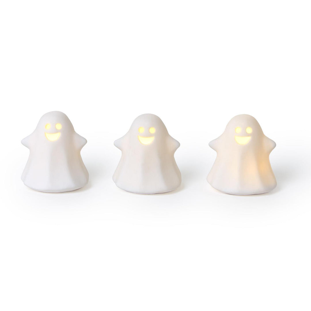 Three ghost-shaped lights glowing on a white background