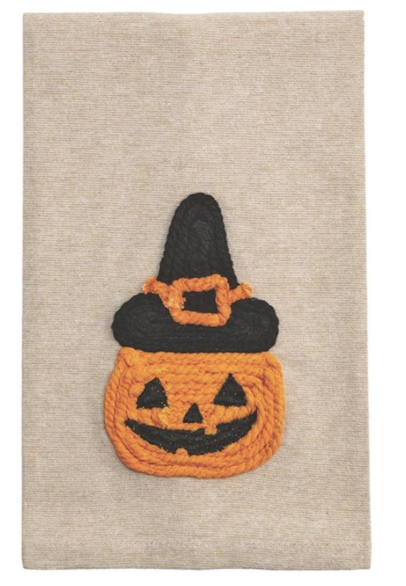 Halloween-themed tea towel with a jack-o'-lantern face and witch hat on a beige fabric background