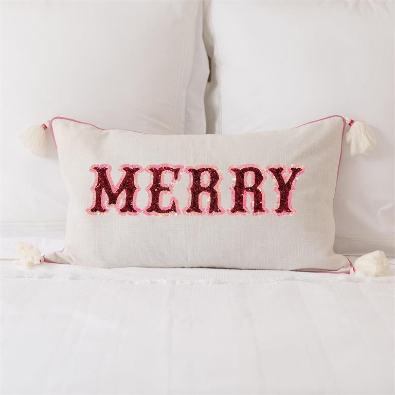Decorative pillow with 'MERRY' text  sitting on a bed