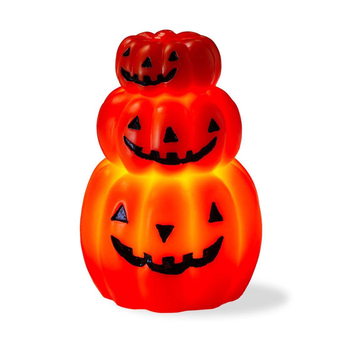 Stack of three orange jack-o'-lanterns with black faces on a white background