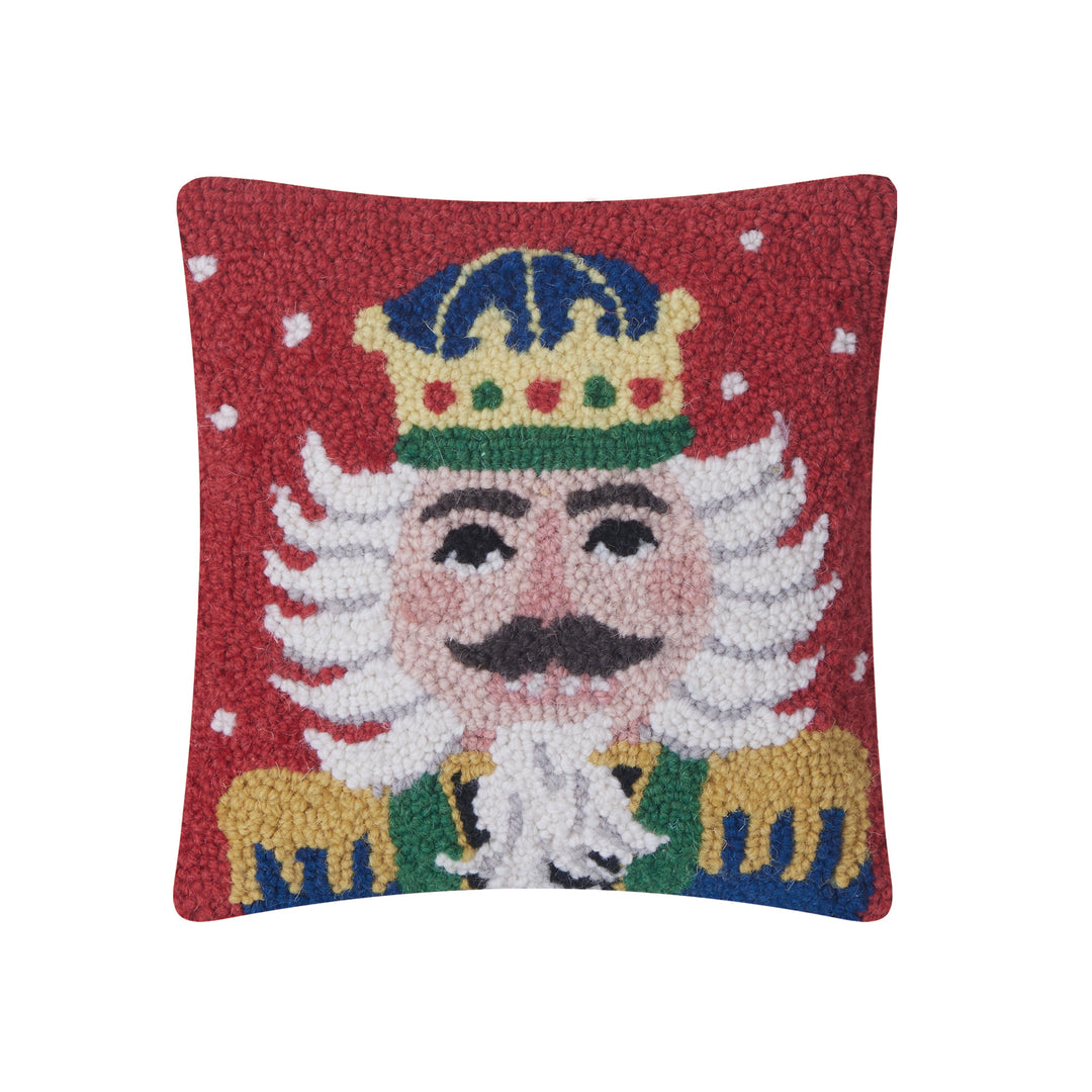 Decorative pillow with a embroidered design of a nutcracker soldier on a red background