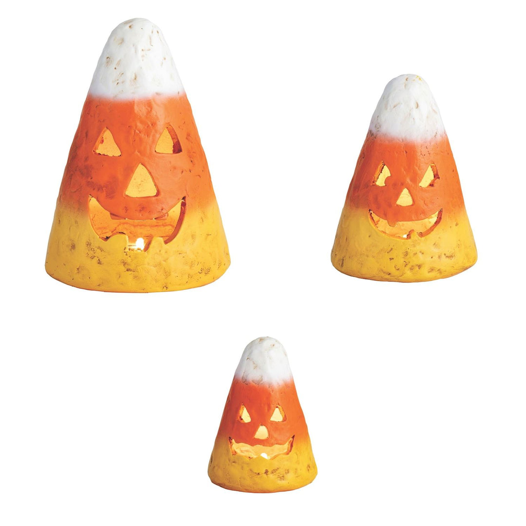 Three candy corn-shaped Halloween lights on a white background