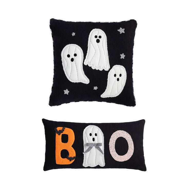 Two Halloween-themed decorative throw pillows on a plain white background. The top pillow is square and black with white ghost figures and small beaded stars.