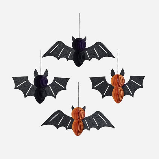 Halloween bat decorations with black wings and orange bodies on a white background