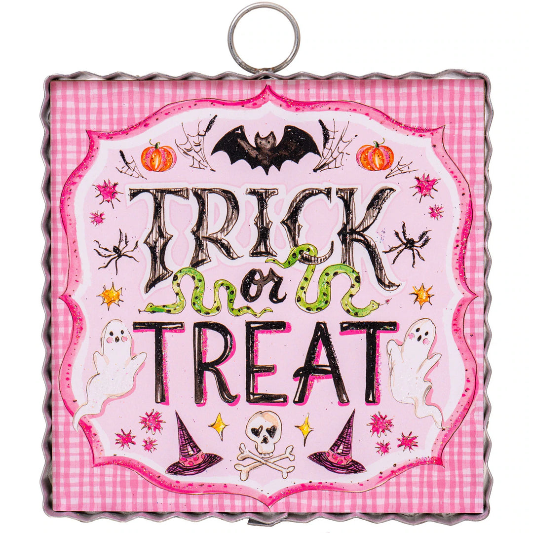 Halloween-themed decorative sign with 'Trick or Treat' text on a pink checkered background.