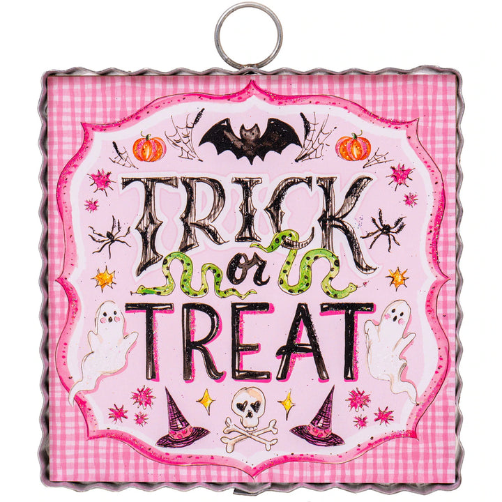 Halloween-themed decorative sign with 'Trick or Treat' text on a pink checkered background.