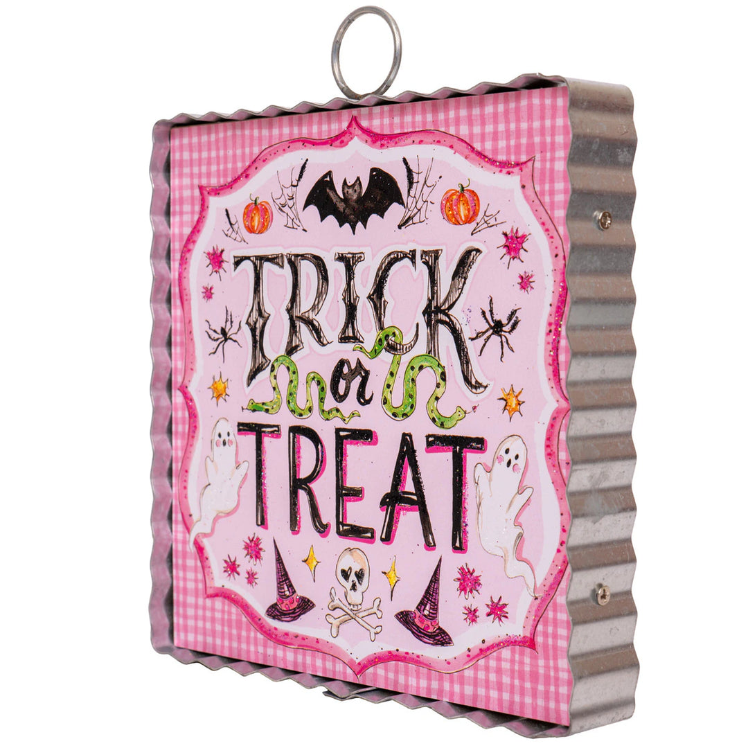 Decorative Halloween sign with 'Trick or Treat' text on a pink checkered background.