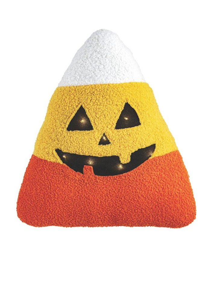Halloween-themed candy corn pillow with a smiling face on a white background